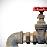 Old water valve on white light background