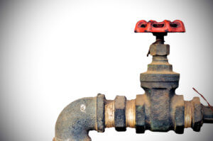 Old water valve on white light background