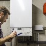man cleaning and maintaining a boiler