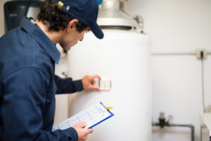 man testing hot water heater