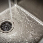 kitchen sink with garbage disposal running