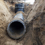 industrial plumbing pipe in a trench