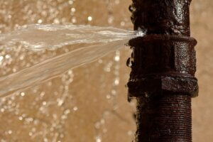 plumbing emergency with pipe squirting water