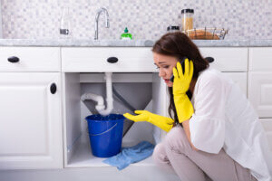 woman calling plumber about drain problems