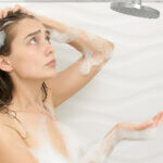 woman in shower worried about water heater
